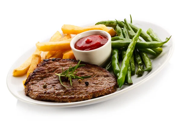 Steaks grillés, pommes de terre cuites au four et légumes — Photo