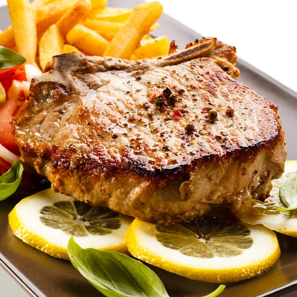 Grilled steak, French fries and vegetables