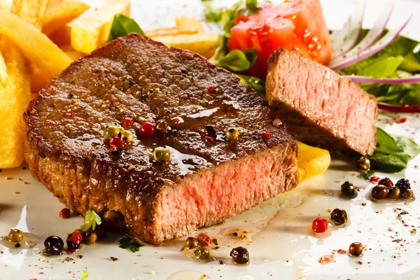 Grilled steak, French fries and vegetables — Stock Photo, Image