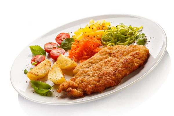 Fried pork chops, baked potatoes and vegetable salad — Stock Photo, Image