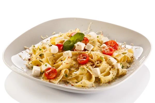 Pasta with tomato and white cheese — Stock Photo, Image