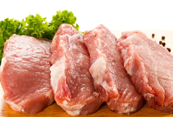 Raw pork chops on cutting board — Stock Photo, Image