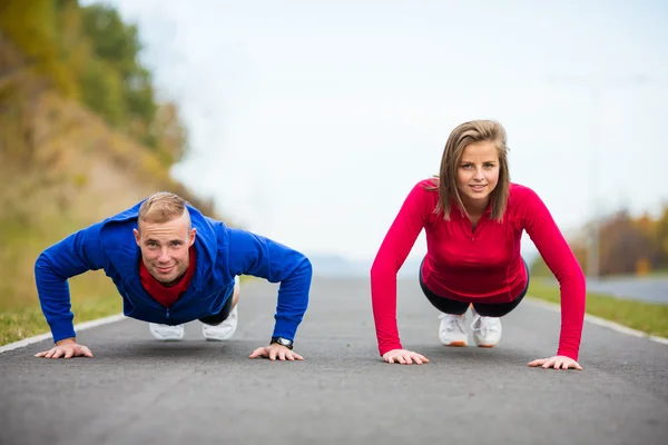 Woman and man exercising — Stock Photo, Image