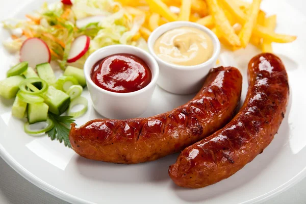 Grilled sausages with chips — Stock Photo, Image