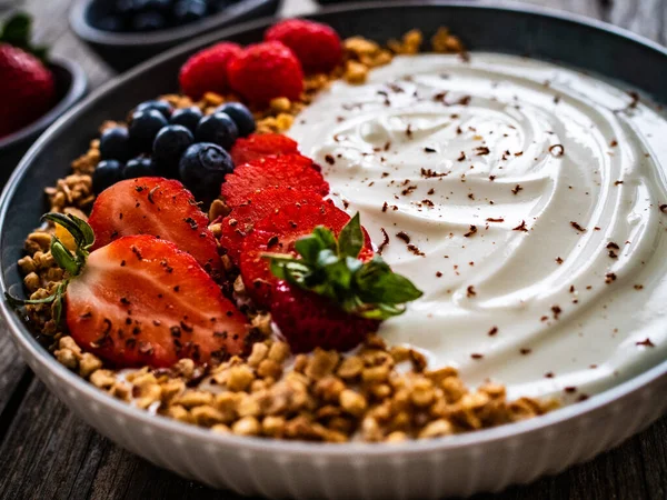 Yogurt Strawberries Blueberries Raspberries Muesli Bowl Wooden Table — Stock Photo, Image