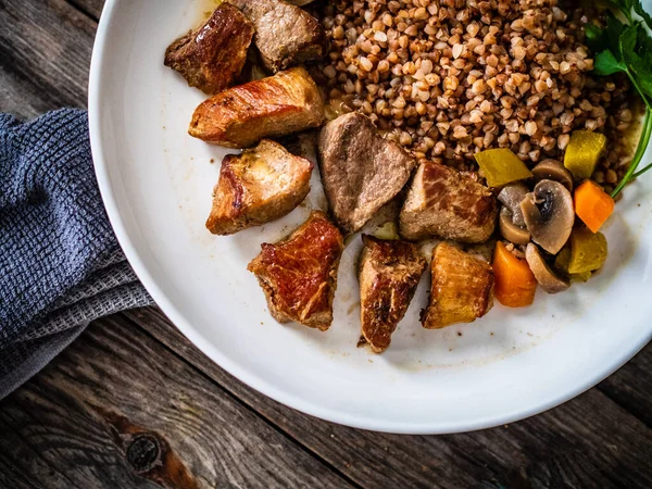 Roast Pork Buckwheat Groats Mushrooms Carrots Served Wooden Table — Stok fotoğraf