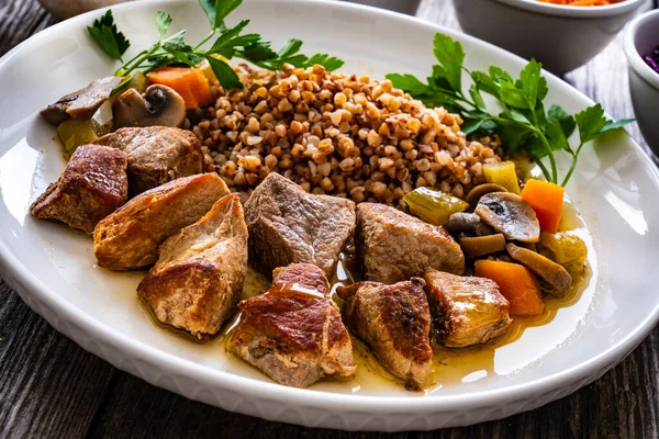 Roast Pork Buckwheat Groats Mushrooms Carrots Served Wooden Table — Stockfoto