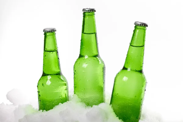 Three beer bottles standing in snow — Stock Photo, Image