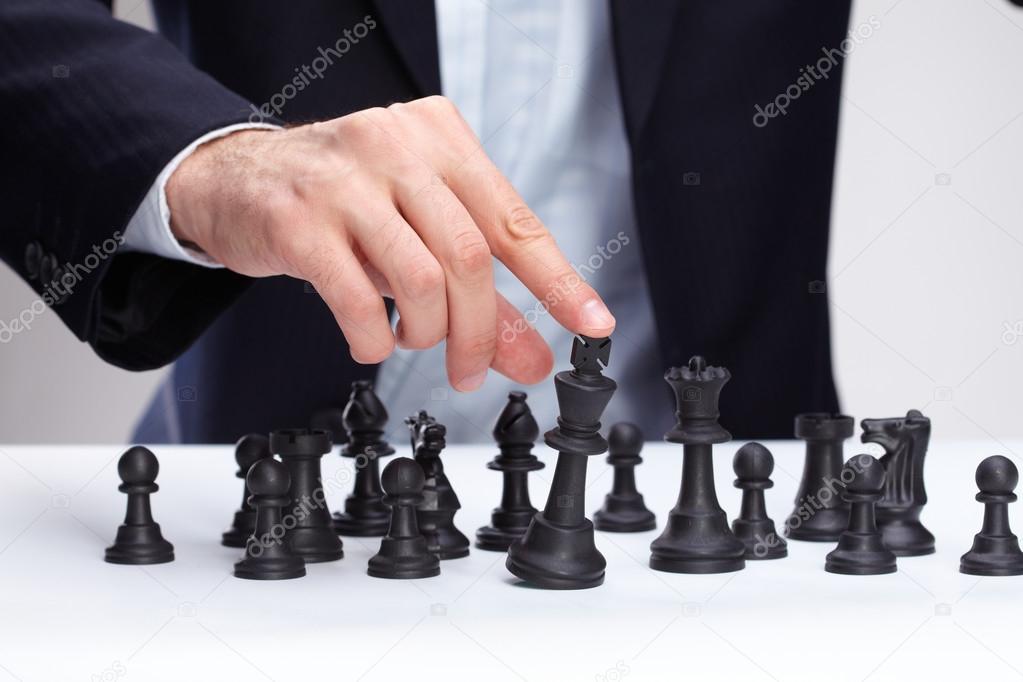 Business man moving chess figure
