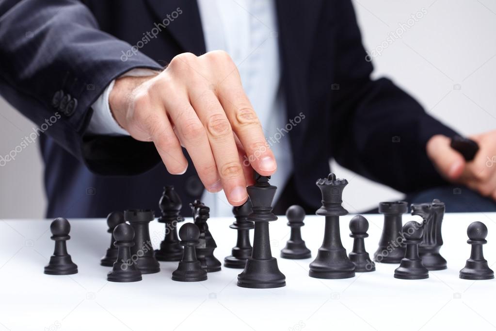 Business man moving chess figure