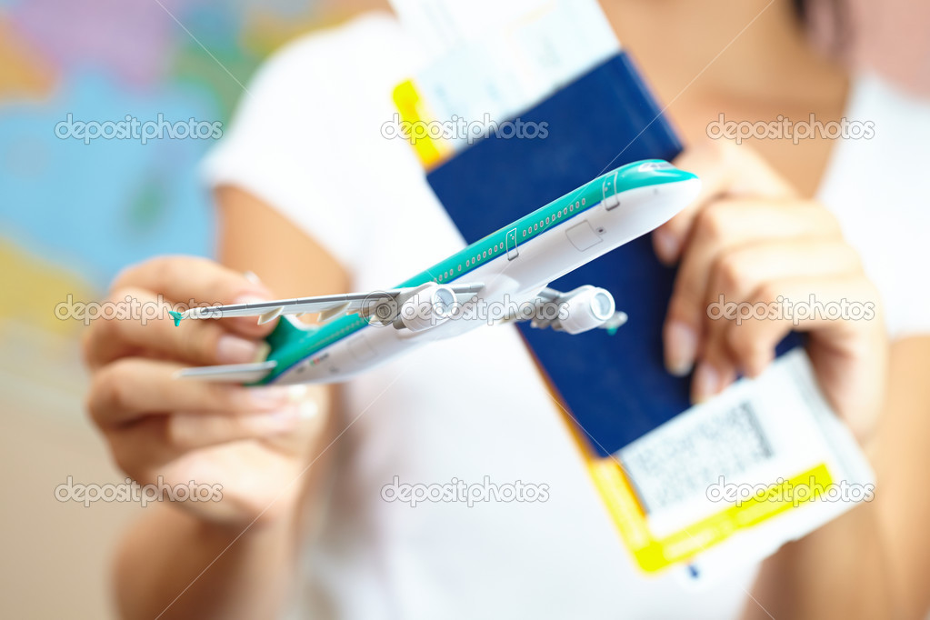 Young Woman Holding Airplane