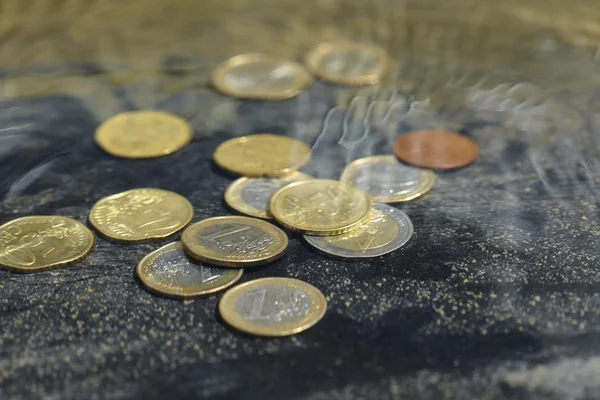 Coins under water — Stock Photo, Image