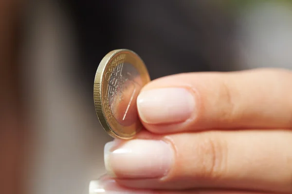 Woman handing coin — Stock Photo, Image