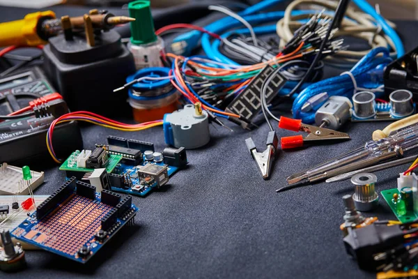 electronic board and tools repairs on black background, close view