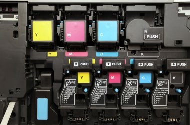 CMYK ink cartridges for laser copier machine clipart