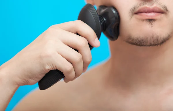 The man shaves a cheek — Stock Photo, Image