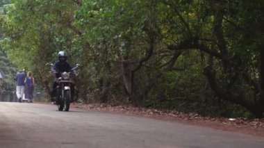 Köyde, GOA, Hindistan 'da motosikletli bir adam.