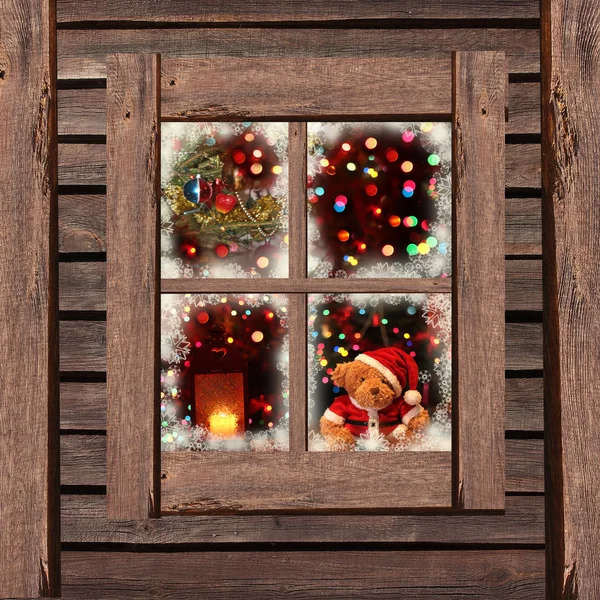 Luces de Navidad vistas a través de una ventana de madera —  Fotos de Stock