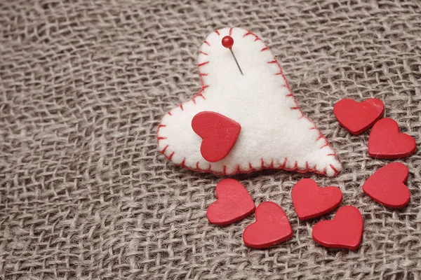 Valentinshintergrund mit handgenähten Herzen — Stockfoto