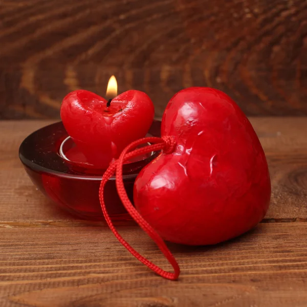 Burning candle heart on vintage wooden background — Stock Photo, Image