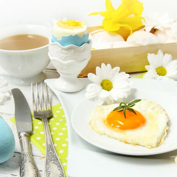 Apparecchiatura della tavola pasquale con fiori e uova su un vecchio tavolo di legno — Foto Stock
