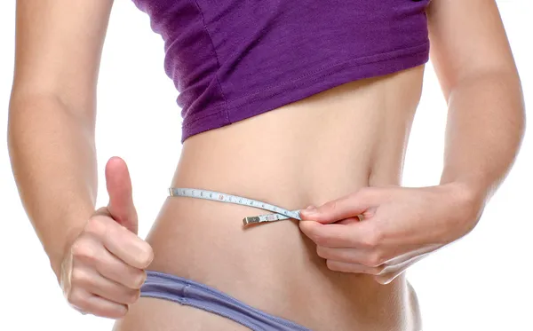 Woman measuring her waist Stock Image