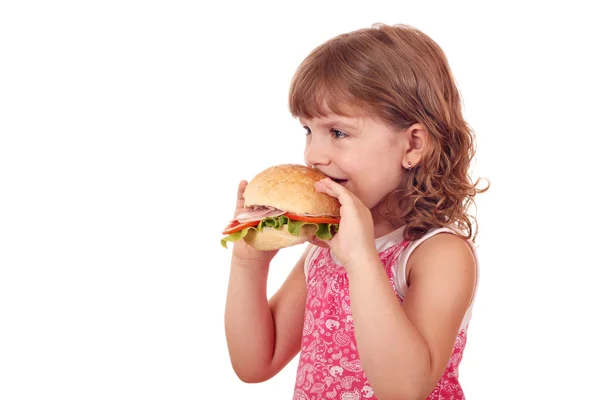 Little girl eats big sandwich — Stock Photo, Image