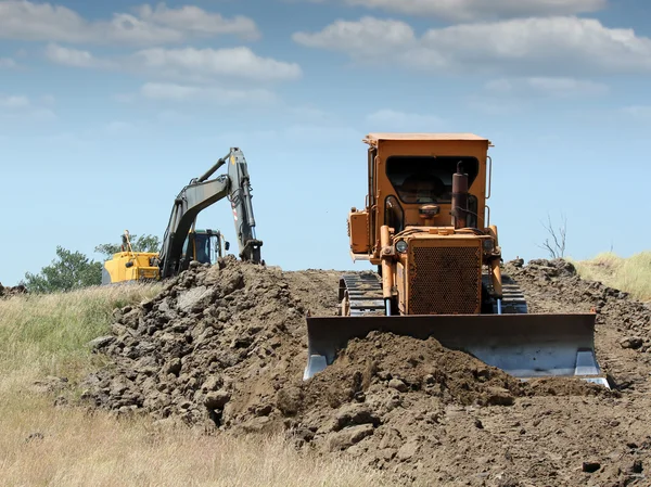 Bulldozer e escavadeira na construção de estradas — Fotografia de Stock