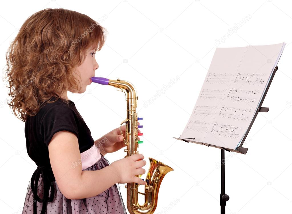 Little girl play music on saxophone