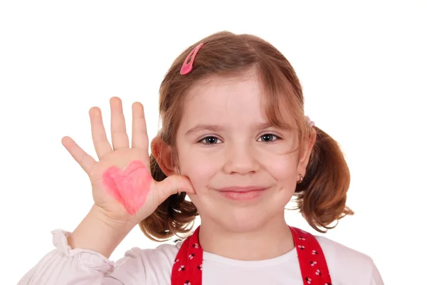 Happy little girl with heart on hand — Stock Photo, Image