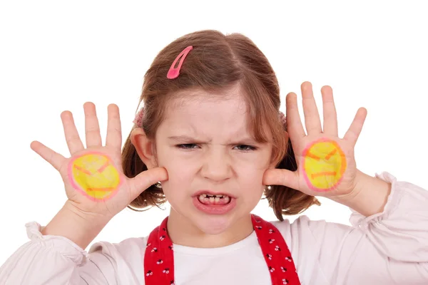 Angry little girl with angry smiley on hands — Stock Photo, Image