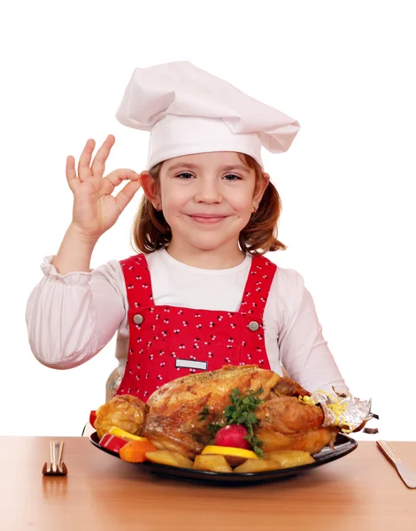 Beautiful little girl cook with grilled chicken — Stock Photo, Image