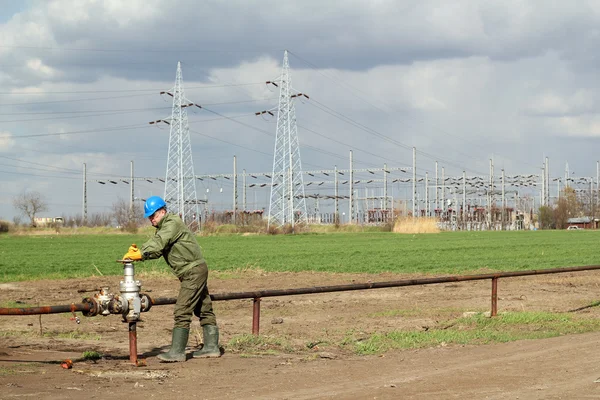 Oil worker open pipeline valve industry zone — Stock Photo, Image