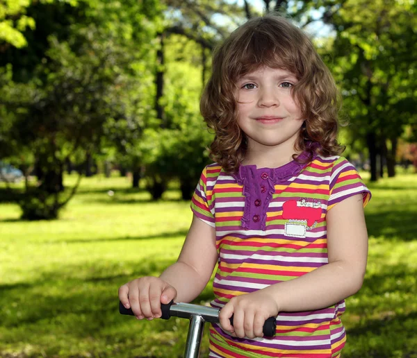 Beautiful little girl in park portrait — Stock Photo, Image