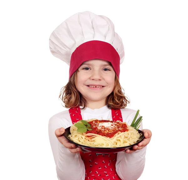 Happy little girl cook holding dish with spaghetti — Stock Photo, Image