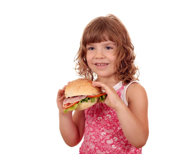 Petite fille affamée avec gros sandwich sur blanc — Photo