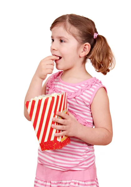 Hungry little girl eat popcorn — Stock Photo, Image