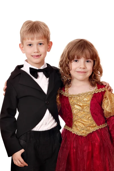 タキシードと肖像画の黄金の赤いドレスで小さな女の子男の子 — ストック写真
