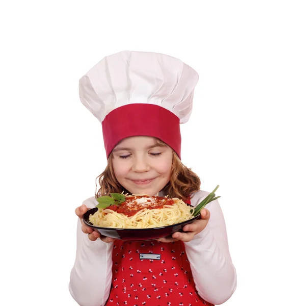 Little girl cook enjoys spaghetti — Stock Photo, Image