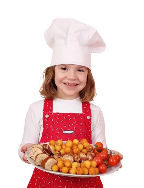 Happy little girl cook hold plate with gourmet food — Stock Photo, Image