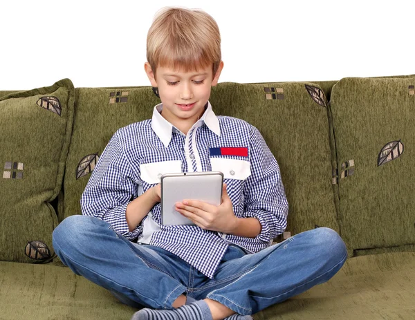 Boy sitting on bed and play with tablet pc — Stock Photo, Image