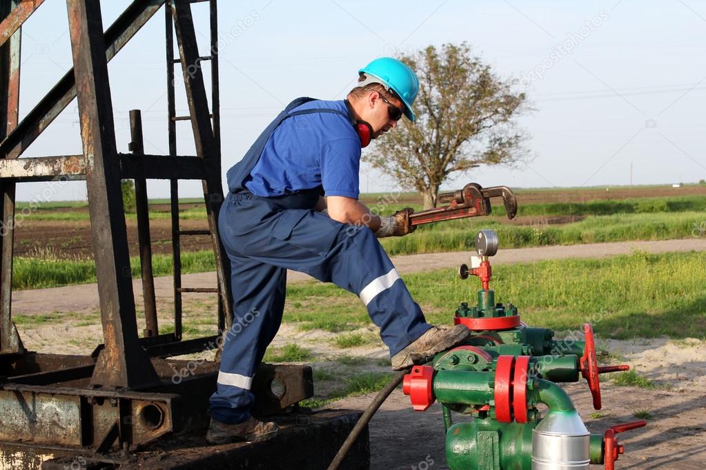oil worker with wrench check pipeline