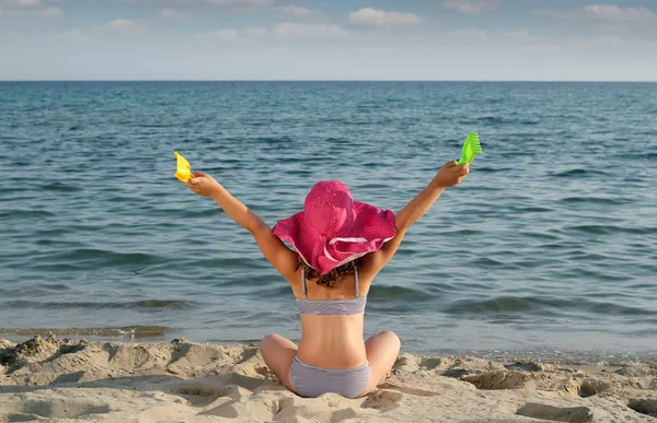 Niña feliz con sombrero mirando al mar — Foto de Stock