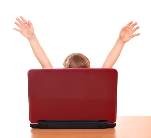 Happy little girl raised his hands behind laptop — Stock Photo, Image