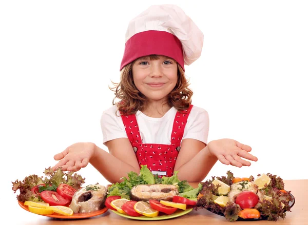 Happy little girl cook with salmon seafood — Stock Photo, Image