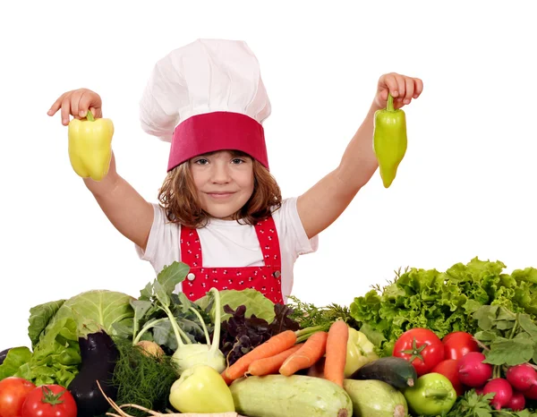 Little girl cook holding peppers — Stock Photo, Image