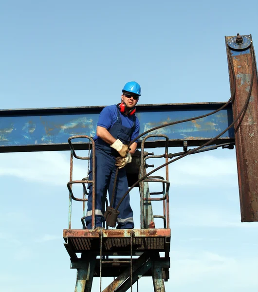 Trabajador petrolero trabajando en gato de la bomba —  Fotos de Stock