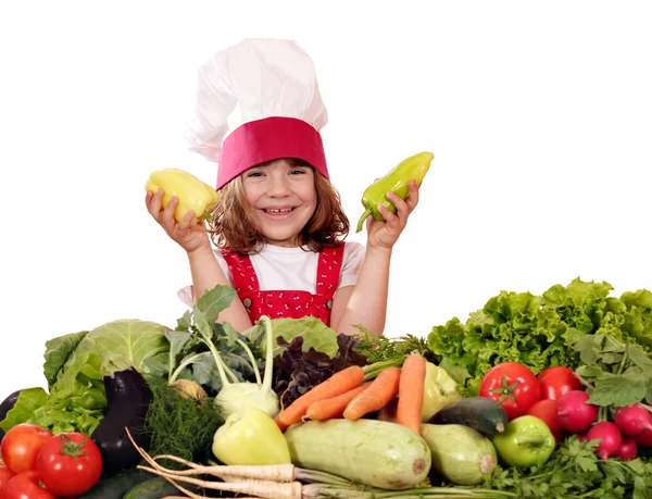 Glad liten flicka koka med paprika och grönsaker — Stockfoto