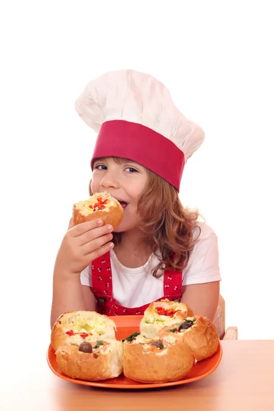 Little girl cook eat bread filled with cheese and vegetables — Stock Photo, Image