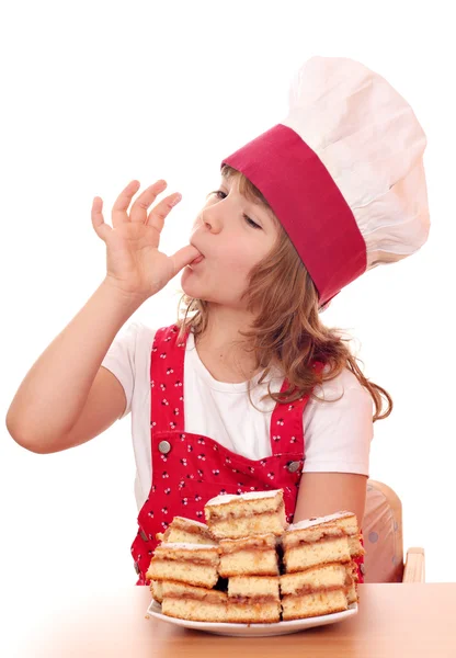 Little girl cook licks the sugar from finger — Stock Photo, Image